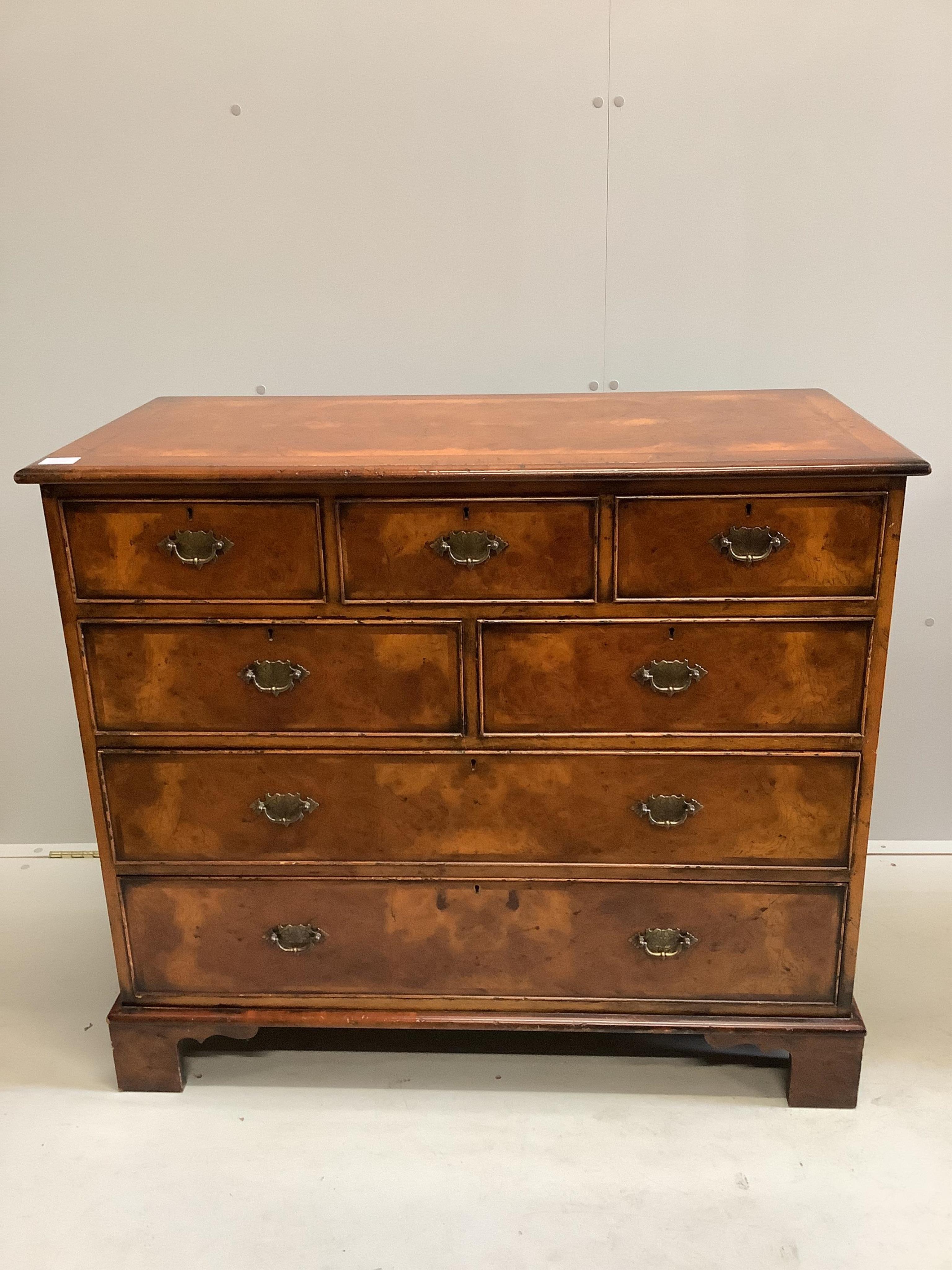 A pair of reproduction George I style feather banded walnut chests of drawers, width 104cm, depth 50cm, height 91cm